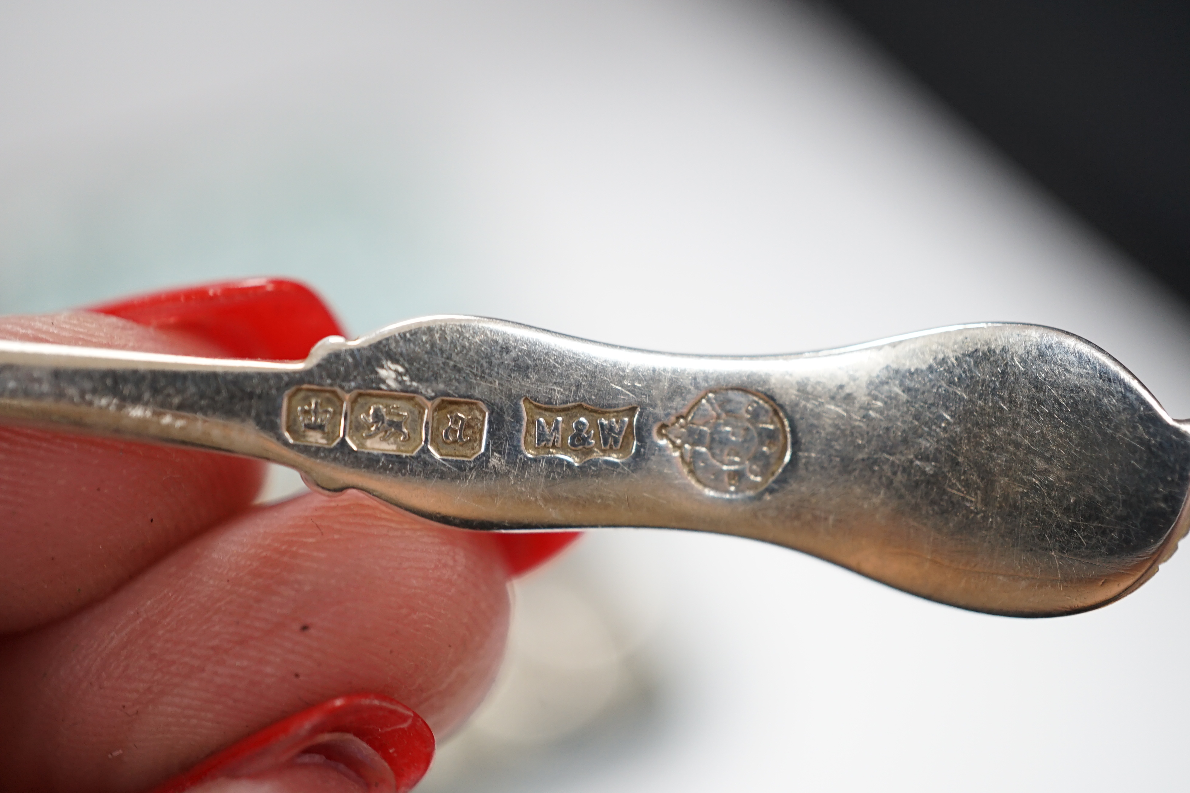 A cased set of six late Victorian silver teaspoons, Mappin & Webb, Sheffield, 1893 and one other later similar cased set with sugar tongs.